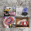 A box of Takara Tomy Metal Fight Collectible Figure S Capricorn M145Q and an accessory in a clear plastic bag.