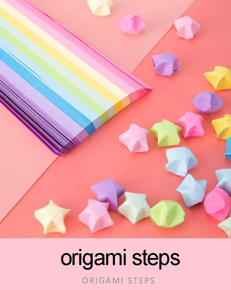 Colorful origami star paper strips and folded shapes arranged on a pink background.