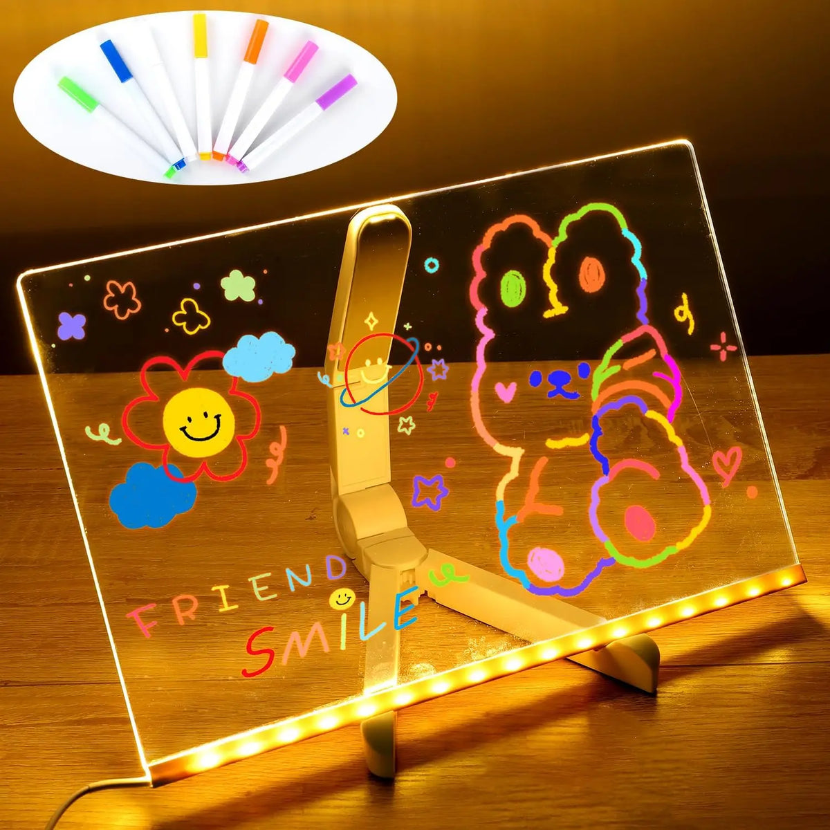 A clear acrylic message board displays colorful drawings and text, illuminated by a light source.