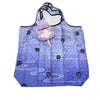 A purple pygmy hippo plush toy with a yellow snout is displayed on a blue fabric bib or feeding mat.