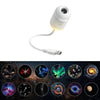 A white projector night light with a lens and cable, shown above various celestial images.
