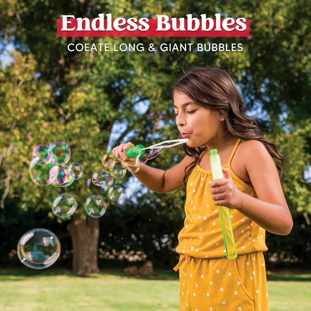 A girl is blowing large bubbles outdoors with a wand, surrounded by many iridescent spheres.