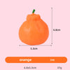 An orange fruit squishy toy with a green stem, measuring 6.8cm by 5.3cm and weighing 37g.