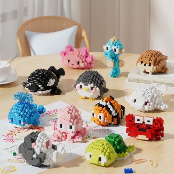 A collection of colorful penguin and sea animal 3D construction figures made of interlocking plastic bricks.