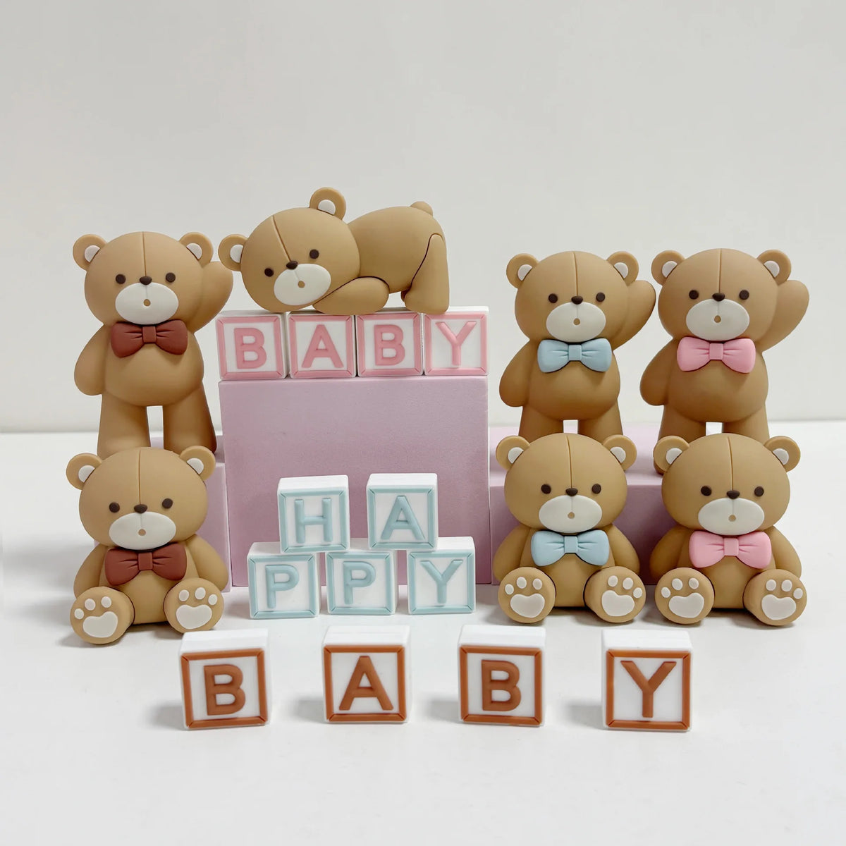 A set of adorable bear cake toppers featuring various sizes and colors for birthday and baby shower decorations.