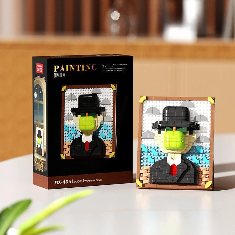 A box and assembled model of a man in a hat made from pixel art building blocks.
