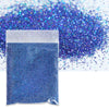A small plastic bag filled with vibrant blue holographic glitter powder scattered on a white surface.