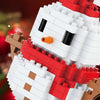 A white and red micro building block figure resembling Santa with a reindeer nose.