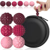A collection of pink and purple magnetic sensory fidget balls with silicone shells arranged around a black zippered pouch.