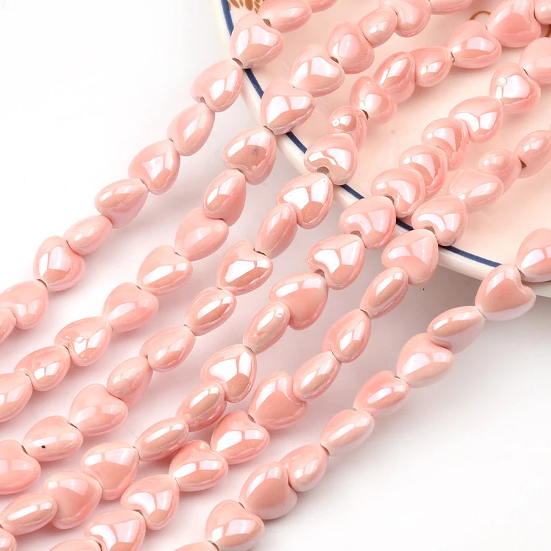 A collection of pink heart-shaped acrylic beads strung together for jewelry making