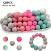 50 pieces of pink and mint green silicone floral beads for DIY jewelry making, displayed in a tray.