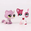 A pair of Shorthair Cat Bobble Head figurines, one pink and white, and one pink and white with a sparkly pink face.