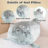 A gray plush seal pillow with a smiling face and a little tail, showing details like super soft plush and vivid expression.