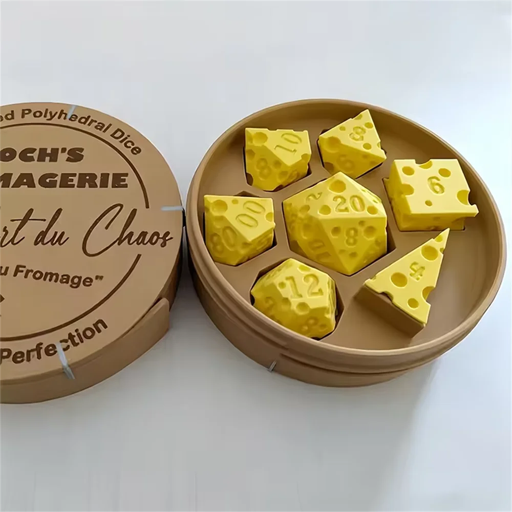 A set of yellow cheese dice cubes arranged on a round wooden platter with a cardboard carrying case nearby.