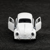 A white 1:38 die-cast model of a classic Beetle car with open doors.