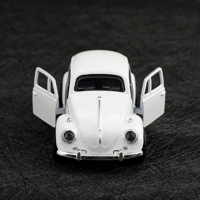 A white 1:38 die-cast model of a classic Beetle car with open doors.