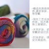 Spools of hand-dyed rainbow merino wool yarn for knitting and crochet