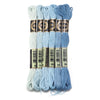 A set of six skeins of vibrant embroidery thread in various shades of light blue and teal for cross stitch and DIY crafts