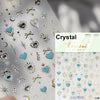 Silver and gold crystal nail art stickers featuring hearts, stars, moons, and crosses