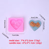 Pink silicone mold shaped like a heart used for making candles or soaps.