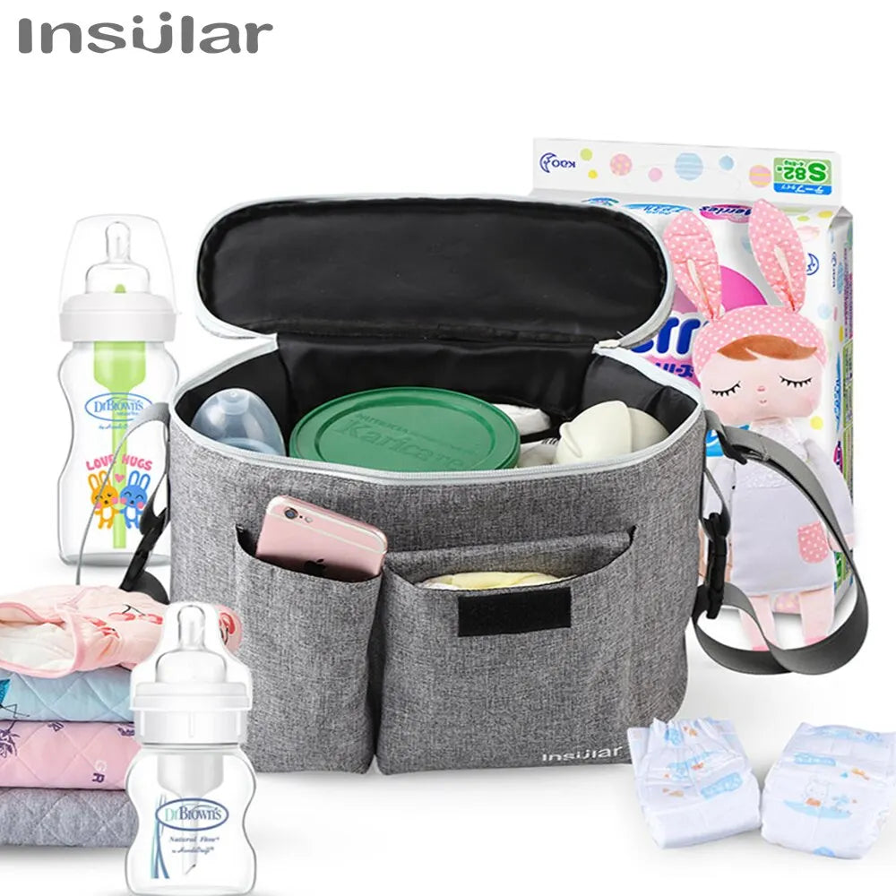 A gray stroller organizer bag with multiple compartments and bottle holders is shown next to a baby doll.