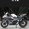 A silver and black 1:12 scale Ninja motorcycle diecast model with lights and sound displayed on a gray surface.