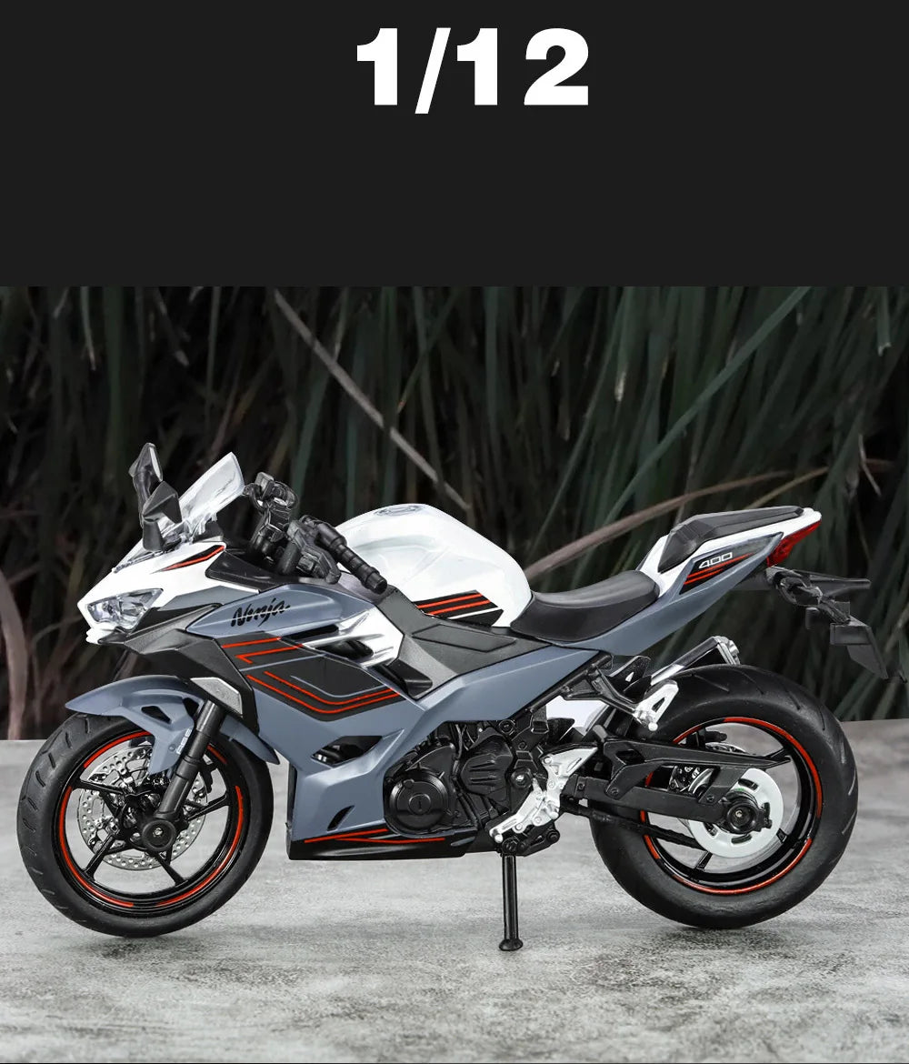 A silver and black 1:12 scale Ninja motorcycle diecast model with lights and sound displayed on a gray surface.