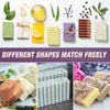 Various shaped silicone soaps in green, yellow, purple, and brown are displayed with wooden casings and a cutting knife.