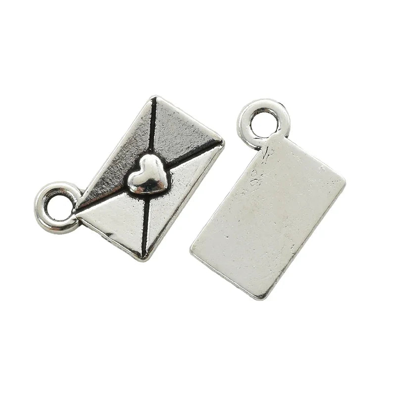 Silver vintage envelope charm with a heart detail and a rectangular silver charm.