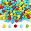 A variety of round, flexible silicone beads in various colors and sizes are displayed on a white background.