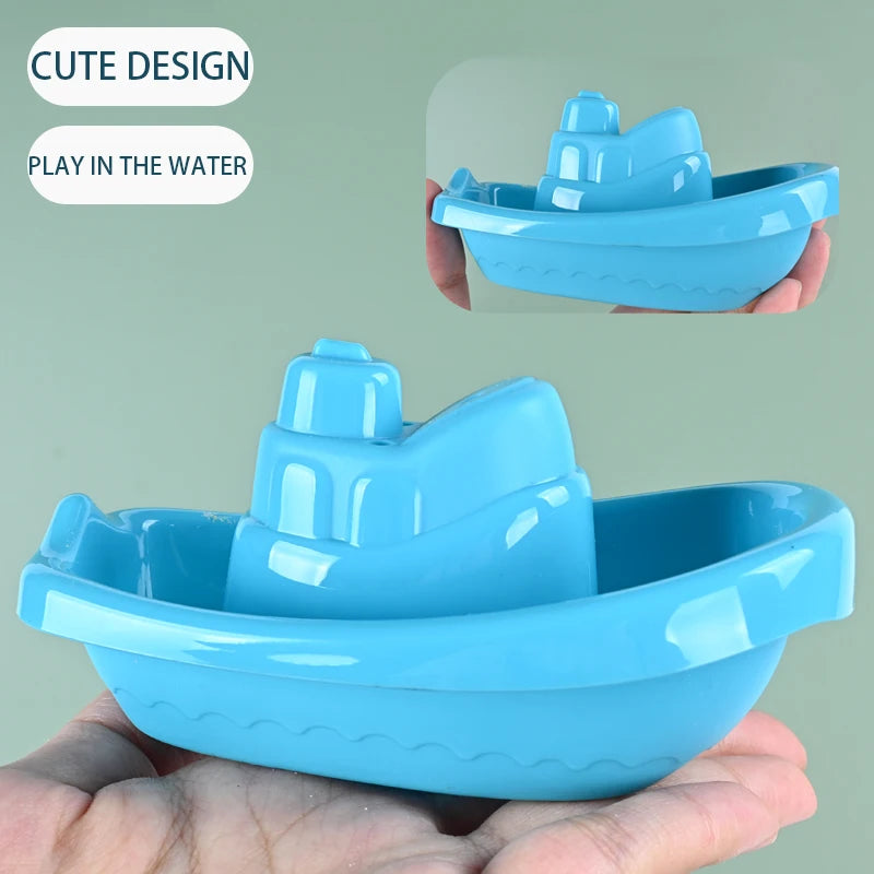 A bright blue floating bath boat toy for kids is shown in hand, demonstrating its cute design and suitability for play in wat