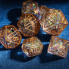A collection of seven amber-colored polyhedral dice set on a dark blue surface.