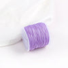 A roll of purple 0.8mm cotton nylon macrame cord for jewelry making and crafts.