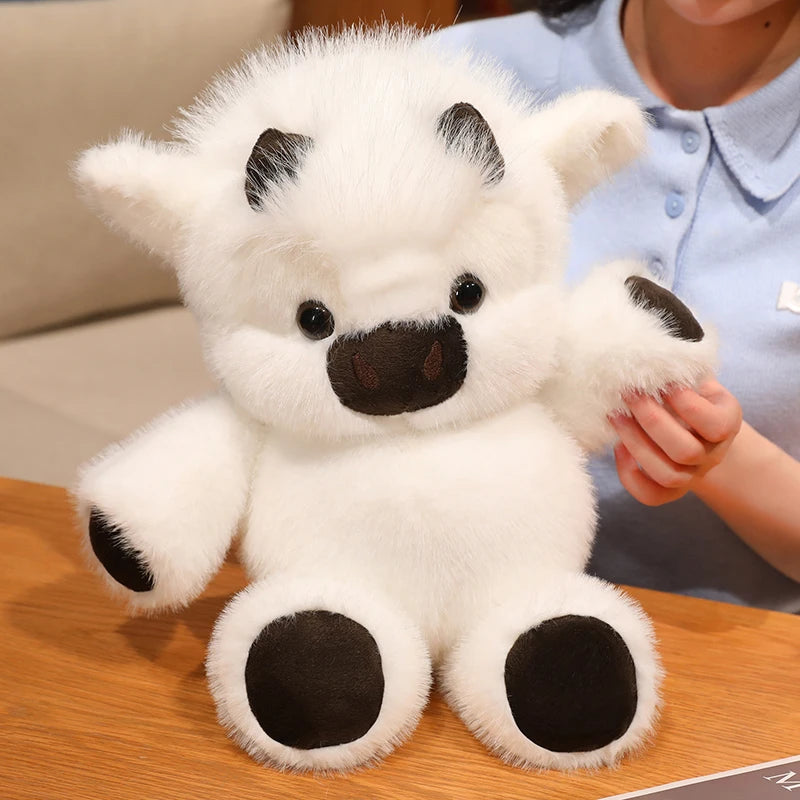 A white plush toy of a West Highland calf, soft and cuddly, being held by a person.