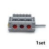A gray motor and servo set for building blocks with red components.