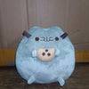 A light blue anime-inspired plush cat doll with brown horns and a cute facial expression.