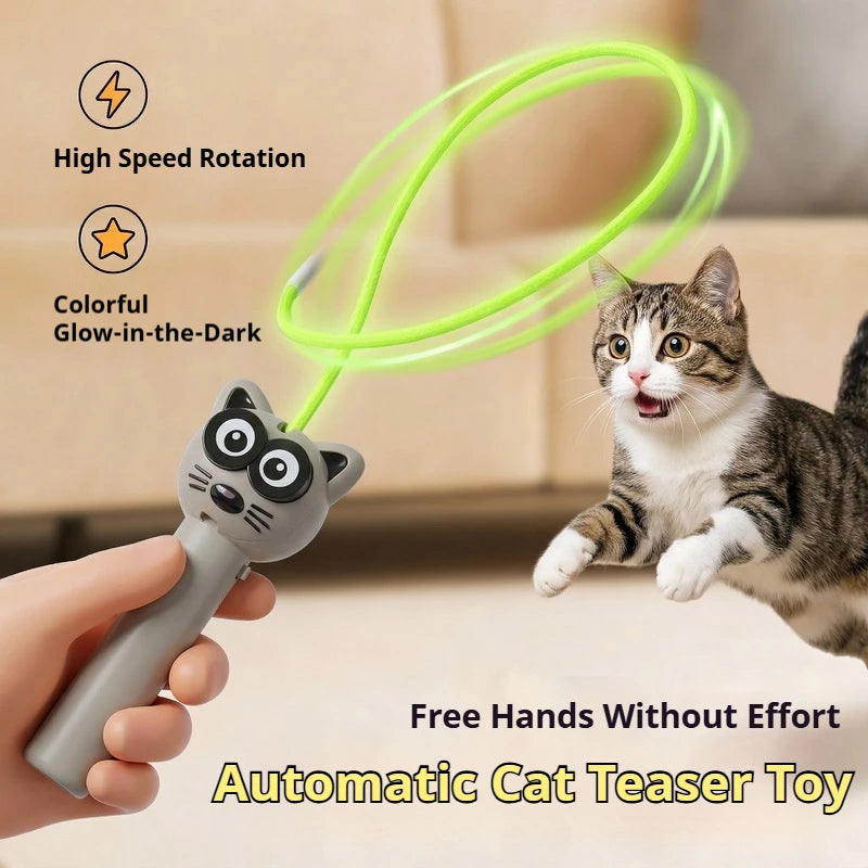 A hand holds a glow-in-the-dark automatic cat teaser toy with a green wire, demonstrating its use for a pet.