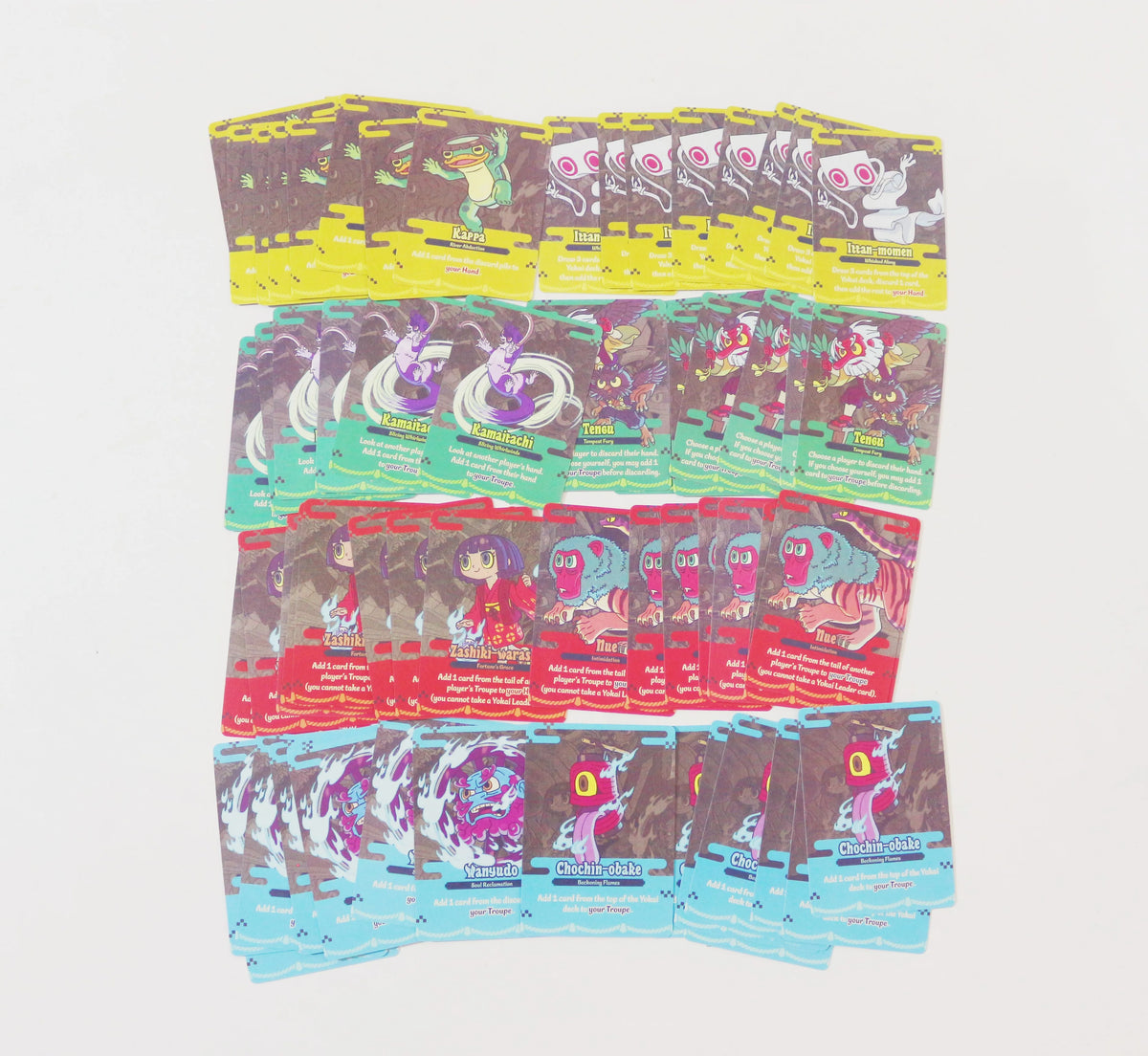 A collection of Yokai Carnival strategic board game decks featuring various colorful illustrations and packaging.