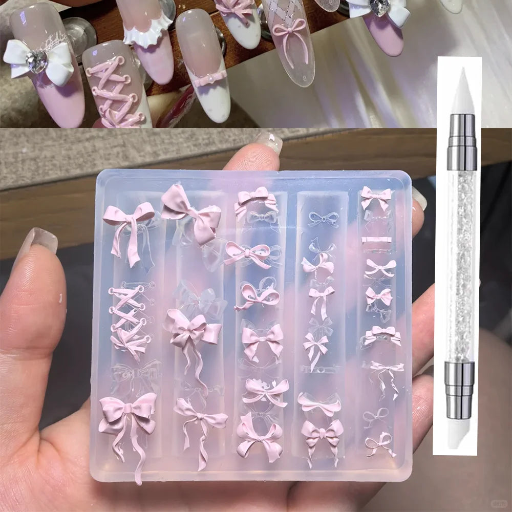 A clear silicone mold tray filled with pink bowknot nail designs and a carving pen.