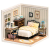 A miniature dollhouse kit depicting a sweet dream bedroom with wooden furniture and striped wallpaper.