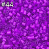 A close-up view of 1000 assorted purple and pink fuse beads for creative craft projects.