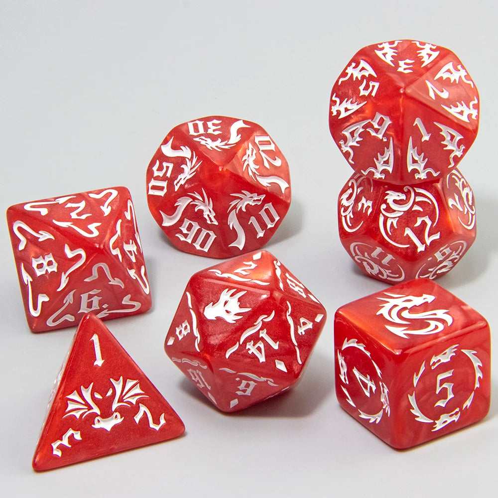 A set of red marble dragon pattern polyhedral dice, including a dodecahedron and a tetrahedron.