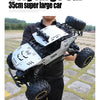 A person holds a white and black high-speed 4WD off-road RC truck with large tires and LED lights.