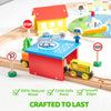 A wooden train set featuring a red building and yellow train, with various magnetic trains and city elements.