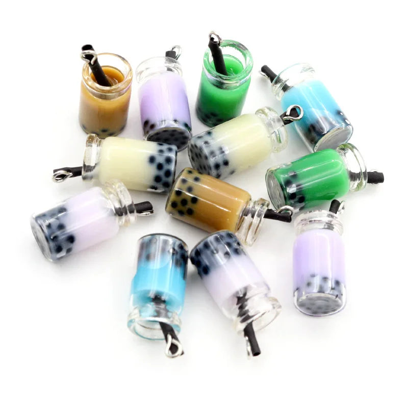 A collection of twenty resin fruit and drink charms in various colors and patterns for jewelry making