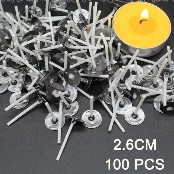A pile of 100 pre-waxed cotton candle wicks with metal sustainers next to a yellow candle.