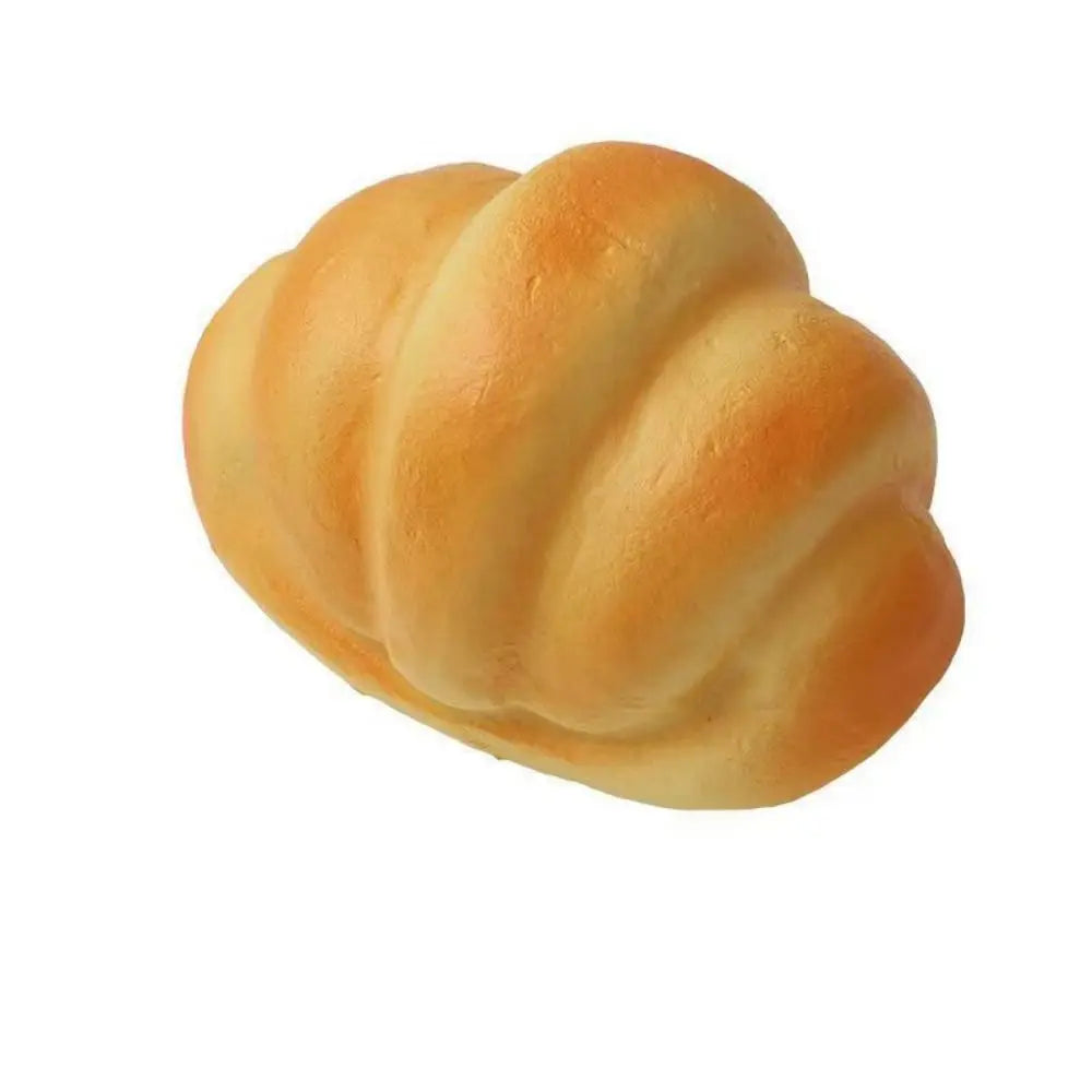 A golden-brown, braided bread loaf shown from the side.