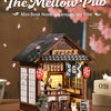 A detailed miniature Japanese izakaya dollhouse kit featuring wooden structures and decorative elements.