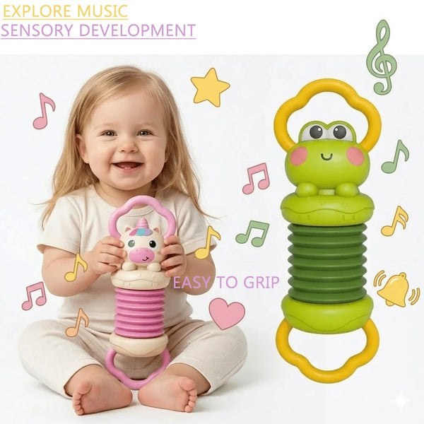A baby is holding a green cartoon frog musical toy designed for sensory development.