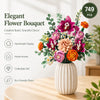 Elegant flower bouquet featuring pink, purple, and orange roses and greenery displayed in a white vase.